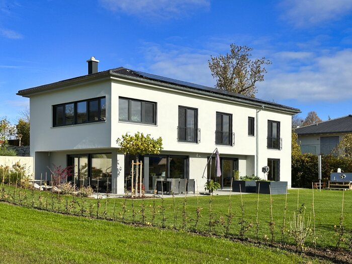 Haus SMS von der Gartenseite mit Terrasse und Sonnenschirm